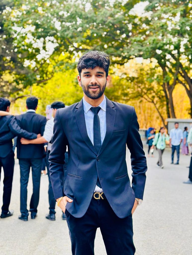 Prem, a solo traveler and business student, smiling outdoors